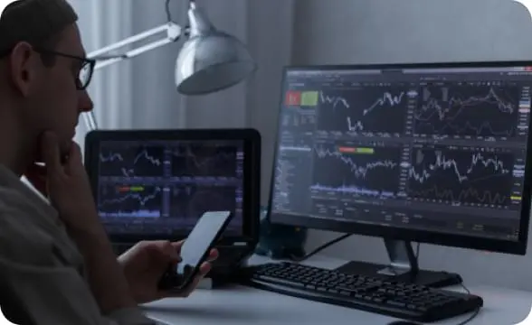 Immediate Profit trader analyzing market data on multiple screens